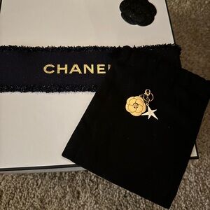 CHANEL Black Pouch with Gold and White Charms